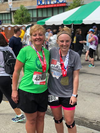 Jackie Goergen posing with Genny Goergen after a race.