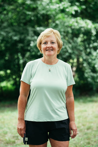 Jackie Goergen in Middle Trail breeze running tee in green.