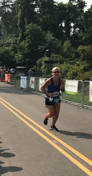 Jackie Goergen running during a half marathon race.