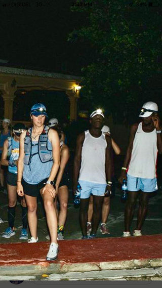 Jackie Whelan getting ready to start her day of running in Haiti with a headlamp on so she can see as she runs in the dark.