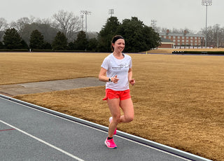 Mackenzie Lowe running on a track.
