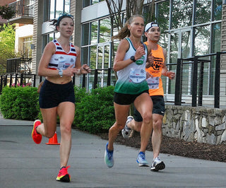 Mackenzie Lowe racing against another girl and a guy runner.