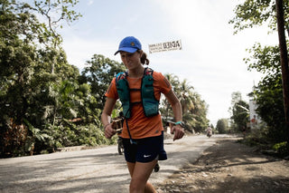 Jackie Whelan smiling and running through the streets of Haiti during her 200-mile Ultra Marathon.