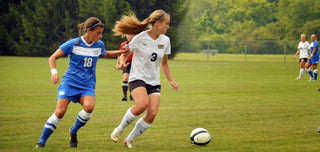 Molly Curry dribbling soccer ball.