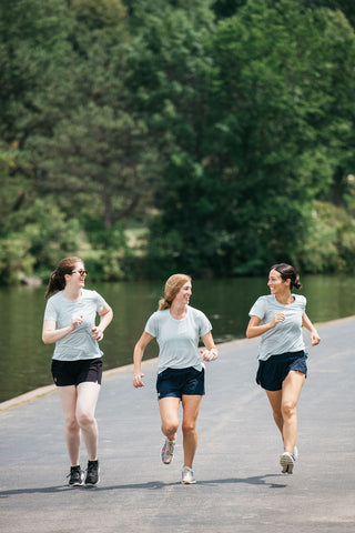 Women's Running Club - Buffalo, NY. Three women running together in Buffalo, NY on a trail near Hoyt Lake in downtown Buffalo. 